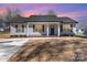 Charming gray home with a black roof, complemented by professionally landscaped yard and a spacious concrete driveway at 206 W 19Th St, Kannapolis, NC 28081