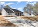 A cozy light-gray home featuring a concrete driveway and well-maintained yard under a beautiful sky at 206 W 19Th St, Kannapolis, NC 28081