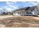 A charming, light-gray house with a well-manicured lawn and concrete driveway on a clear, sunny day at 206 W 19Th St, Kannapolis, NC 28081