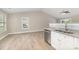 Open kitchen features stainless steel appliances, gray granite countertops, white cabinets and eat-in area at 206 W 19Th St, Kannapolis, NC 28081