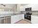 Kitchen features stainless steel appliances, gray granite countertops, white cabinets, and recessed lighting at 206 W 19Th St, Kannapolis, NC 28081