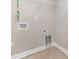 Laundry room features hook ups, shelving, and light colored flooring at 206 W 19Th St, Kannapolis, NC 28081