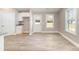 Light and bright open-concept living room with gray cabinets, white trim, and wood-look flooring at 206 W 19Th St, Kannapolis, NC 28081