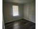 This cozy bedroom is brightened by natural light and features updated flooring at 2312 Tate St, Charlotte, NC 28216