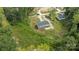 An aerial view showcases the home, a gravel driveway and the surrounding treed and natural setting at 253 Artemis Pl # 27, Kershaw, SC 29067