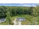 Aerial view of a well-maintained single-story home surrounded by lush, mature trees at 253 Artemis Pl # 27, Kershaw, SC 29067