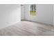 Bright bedroom with light wood-look flooring, a large window, and white trim at 253 Artemis Pl # 27, Kershaw, SC 29067