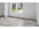 Clean, spacious bedroom with light wood-look flooring and natural light from the windows at 253 Artemis Pl # 27, Kershaw, SC 29067