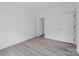 Bright bedroom with white walls, wood-look floors, and white doors at 253 Artemis Pl # 27, Kershaw, SC 29067