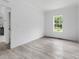 Neutral bedroom featuring a large window and light wood-look floors at 253 Artemis Pl # 27, Kershaw, SC 29067