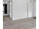 Bright bedroom with light wood-look flooring, white walls, and a view into the ensuite bath at 253 Artemis Pl # 27, Kershaw, SC 29067
