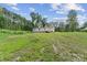 View of the exterior of the home with its muted siding, green lawn and natural wooded backdrop at 253 Artemis Pl # 27, Kershaw, SC 29067
