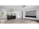 Open living room with modern kitchen, wood-look floors, and plenty of light at 253 Artemis Pl # 27, Kershaw, SC 29067