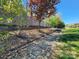Tranquil backyard featuring mature trees, a decorative creek bed, and lush greenery at 2741 Smethwick Ln, Gastonia, NC 28056