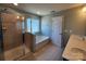 Bathroom featuring tile flooring, separate shower, soaking tub, window, and door at 2741 Smethwick Ln, Gastonia, NC 28056