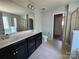 Bright bathroom with dual sink vanity, tiled floor, large mirror and separate shower and toilet rooms at 2741 Smethwick Ln, Gastonia, NC 28056
