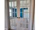 View through glass french doors into bedroom with accent wall and ceiling fan at 2741 Smethwick Ln, Gastonia, NC 28056