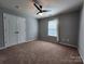 Bedroom boasts a ceiling fan, closet, and neutral carpet at 2741 Smethwick Ln, Gastonia, NC 28056