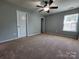 Spacious carpeted bedroom with ceiling fan and window, offering ample natural light at 2741 Smethwick Ln, Gastonia, NC 28056