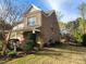 Side view of home with brick exterior, well maintained yard, and manicured landscaping at 2741 Smethwick Ln, Gastonia, NC 28056