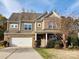 Beautiful two-story home featuring a brick and siding facade, an attached two-car garage, and a well-maintained front yard at 2741 Smethwick Ln, Gastonia, NC 28056