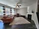 Cozy living room with hardwood floors, a fireplace, and large windows at 2741 Smethwick Ln, Gastonia, NC 28056