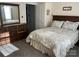 Cozy bedroom featuring neutral walls, carpet, a window, and a wooden dresser at 307 Gold Hill Ave, Rockwell, NC 28138