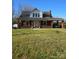 Charming red brick two-story home with a covered porch and carport, set on a grassy lot at 307 Gold Hill Ave, Rockwell, NC 28138