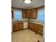 Bright kitchen with tiled floors, white appliances, light countertops, and abundant cabinet storage at 307 Gold Hill Ave, Rockwell, NC 28138