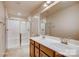 Bathroom featuring a double sink vanity and a tiled shower at 319 Pond Place Ln, Matthews, NC 28104