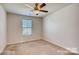 Bedroom with neutral carpet, ceiling fan and bright window at 319 Pond Place Ln, Matthews, NC 28104