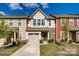 Charming townhome with attached garage, stone accents and landscaped yard on a beautiful partially cloudy day at 319 Pond Place Ln, Matthews, NC 28104
