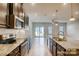 Well-appointed kitchen with stainless steel appliances and granite countertops, open to the living space at 319 Pond Place Ln, Matthews, NC 28104