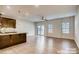 Well-lit open-concept layout with hardwood flooring, seamlessly connecting the kitchen and the living area at 319 Pond Place Ln, Matthews, NC 28104