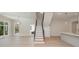 Open-concept living room with staircase and hardwood floors at 3200 Providence Rd # 1B, Charlotte, NC 28211