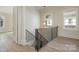 Staircase with modern iron railing and hardwood steps and floors at 3200 Providence Rd # 1B, Charlotte, NC 28211