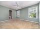 Bedroom with neutral carpet, two windows, a ceiling fan, and a door to the bathroom at 321 Rose Garden Ct, Rock Hill, SC 29732