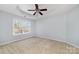 A bright bedroom features a tray ceiling and large window at 321 Rose Garden Ct, Rock Hill, SC 29732