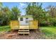 Wooden deck leading to a white home exterior, with mature landscaping at 3221 Cosby Pl, Charlotte, NC 28205