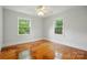 Bright bedroom featuring hardwood floors, natural light, and a ceiling fan at 3221 Cosby Pl, Charlotte, NC 28205