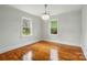 Bright bedroom featuring hardwood floors, fresh paint, and modern lighting at 3221 Cosby Pl, Charlotte, NC 28205