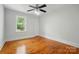 Cozy bedroom with hardwood floors, neutral paint, ceiling fan, and natural light at 3221 Cosby Pl, Charlotte, NC 28205