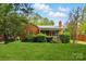 Charming red brick home featuring a well-manicured lawn and mature landscaping at 3221 Cosby Pl, Charlotte, NC 28205