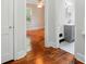 Hallway view of bedroom and bathroom with hardwood floors and fresh paint at 3221 Cosby Pl, Charlotte, NC 28205