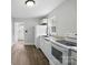 Bright kitchen with white cabinets, modern appliances, and wood-look floors at 3221 Cosby Pl, Charlotte, NC 28205