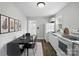 Eat-in kitchen with white cabinets and modern appliances next to a table at 3221 Cosby Pl, Charlotte, NC 28205