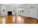 Bright living room featuring hardwood floors, a fireplace, and large windows at 3221 Cosby Pl, Charlotte, NC 28205
