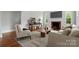 Inviting living room featuring hardwood floors, a fireplace, and natural light at 3221 Cosby Pl, Charlotte, NC 28205