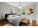 Serene main bedroom featuring a decorative chandelier, large windows, and cozy bed at 3221 Cosby Pl, Charlotte, NC 28205