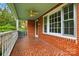 Inviting brick porch with a decorative tile floor and a ceiling fan at 3221 Cosby Pl, Charlotte, NC 28205
